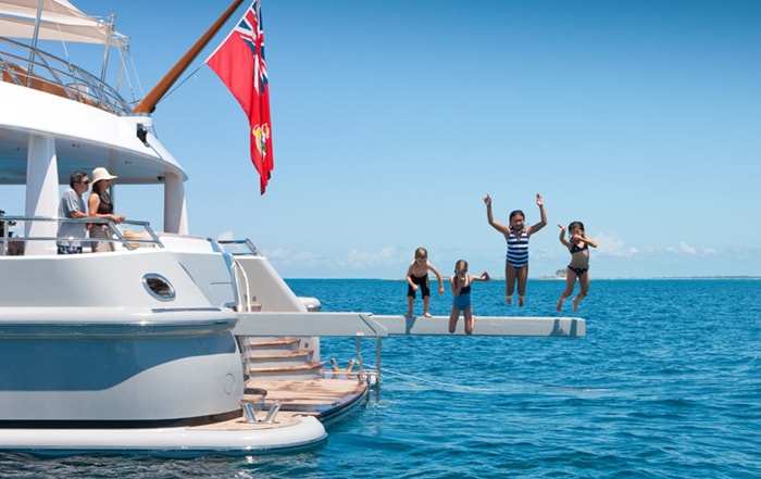 Children jumping off a yacht